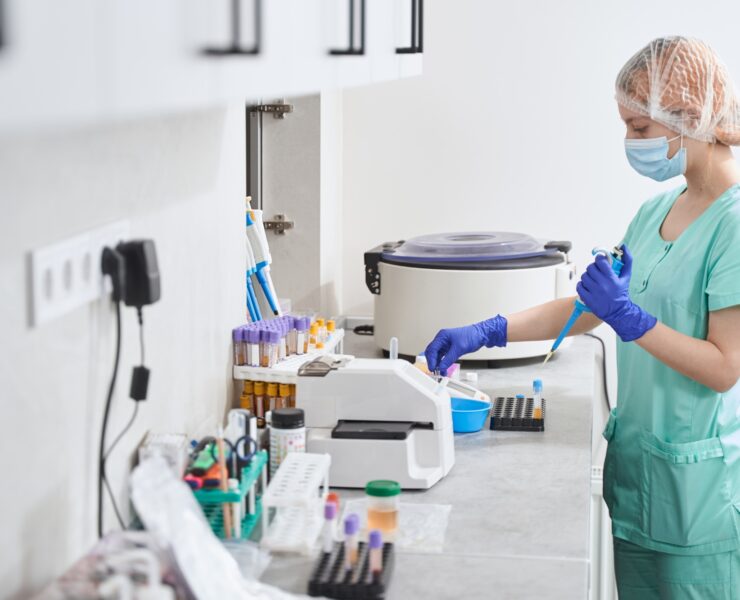 Female in medical suit working in laboratory