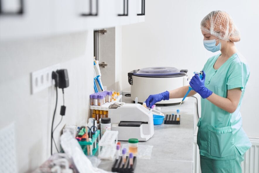 Female in medical suit working in laboratory